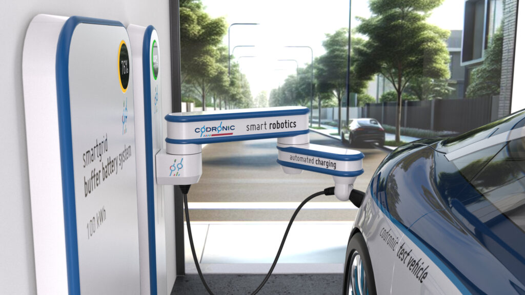 A Picture of a robot, mounted on the wall, inserting a charging plug into a electric vehicle.